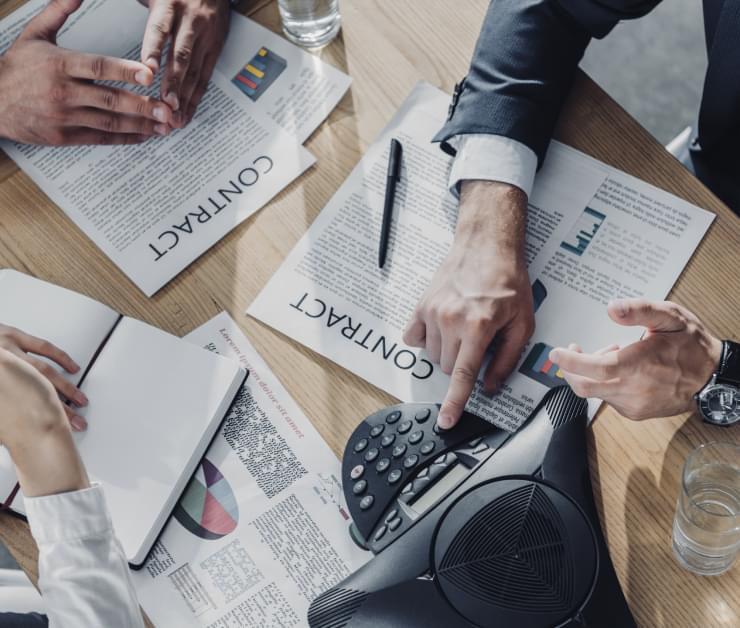 business meeting showing hands and signing contracts
